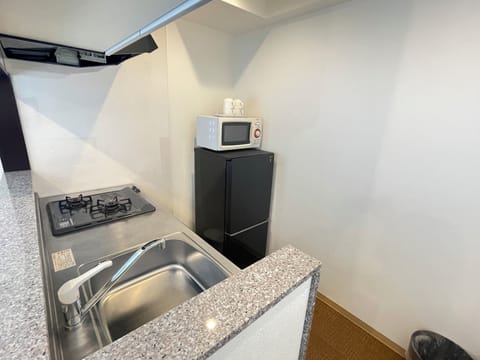 Family Quadruple Room | Private kitchen | Full-size fridge, microwave