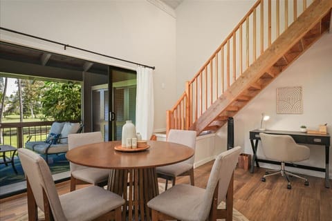Dining area with vaulted ceilings and sliders to covered lanai