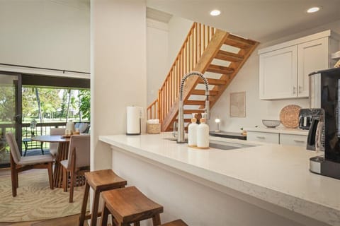 Full kitchen with breakfast bar and stainless steel appliances