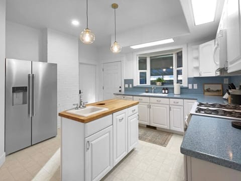 Large newly remodeled kitchen with new appliances and a center island.