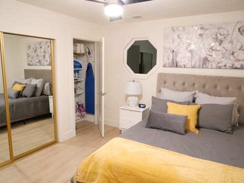 Luxurious Queen Bed master bedroom with large closet and supply closet.