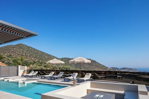 The poolside ambiance is enhanced by an ensemble of 6 sun beds, side tables, 2 cozy bean bag chairs, 4 umbrellas, and a refreshing hot water-equipped poolside shower.