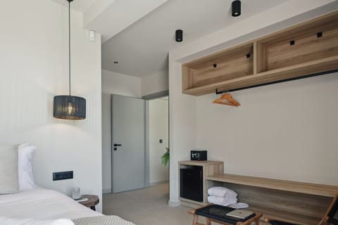 This room also features an ensuite bathroom, a 43’’ TV, and access to a staircase that leads up to the inviting pool terrace