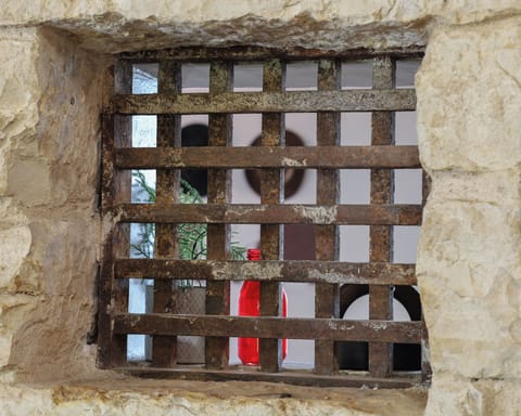 Original jail bar window looking through the "old exterior wall"