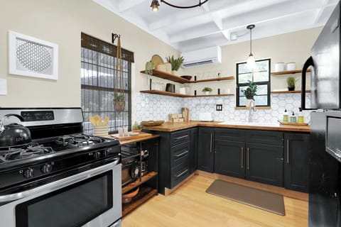 The kitchen is equipped with modern appliances and amble storage space