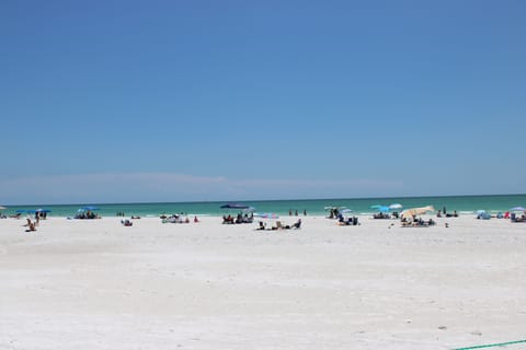 Beach nearby, white sand, beach towels