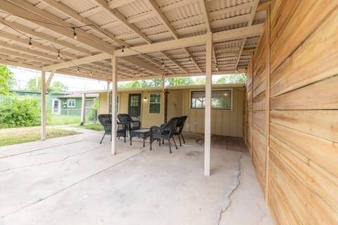 ️ Enchanting Covered Patio! ✨ Relax in your large, private patio adorned with furniture and cozy string lights. The tin roof creates a magical rain soundtrack, perfect for blissful moments. ️