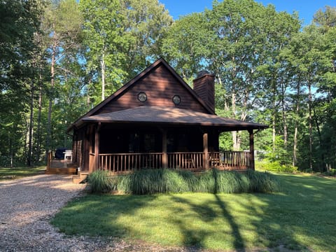 Calm Water Cabin in the spring - surrounded by lush green grasses and trees.