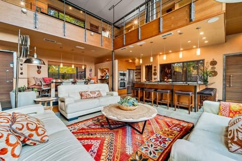 Wide living area connected to the kitchen and second dining area.