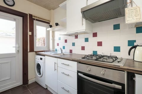 compact modern kitchen has all your essentials, washing machine, fridge & coffee