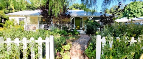 beautiful gardens, tree-lined street, walkable neighborhood.