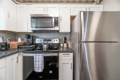 Fully stocked kitchen including stainless steel appliances and small appliances.