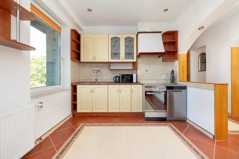 Additional kitchen perspective featuring wooden cabinetry, a built-in oven, and plenty of counter space.
