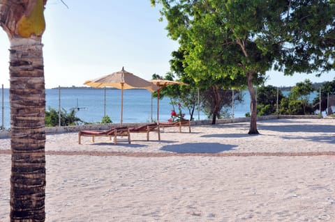 On the beach, white sand, sun loungers, beach umbrellas