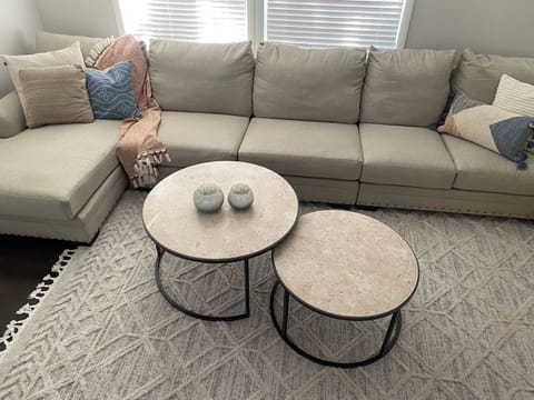 The living room has a 70" smart TV and large sectional couch