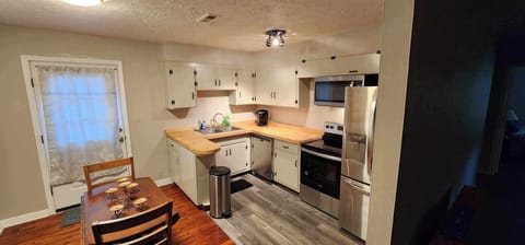 Dinning area and back deck door. Laundry to left and kitchen to right.