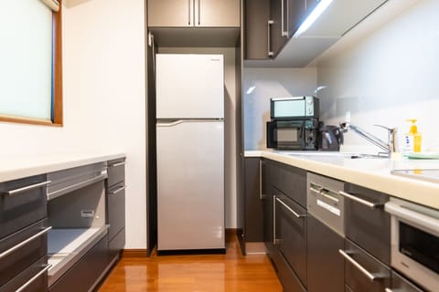 Luxury Apartment | Private kitchen | Full-size fridge, microwave, stovetop, electric kettle