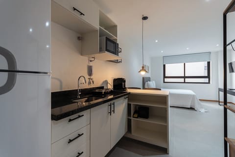 Basic Studio | Private kitchen | Fridge, stovetop, espresso maker, dining tables