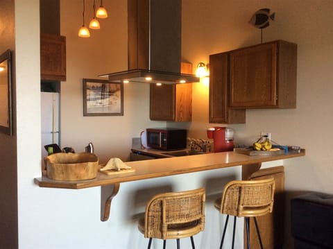 Kitchen has been opened up for ocean view while cooking