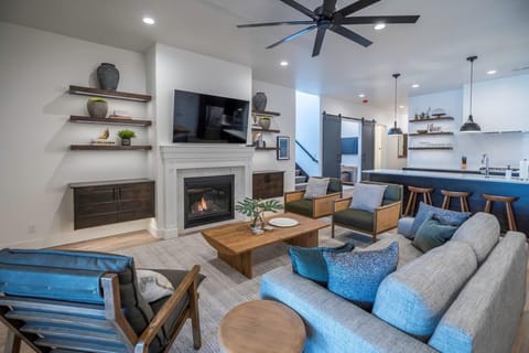 Main floor living room with sofa + chair seating, cable TV, and fireplace