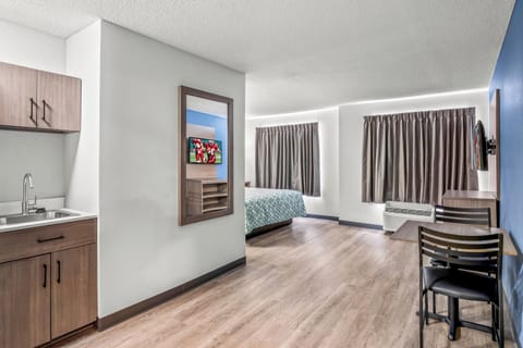 Desk, laptop workspace, blackout drapes, iron/ironing board