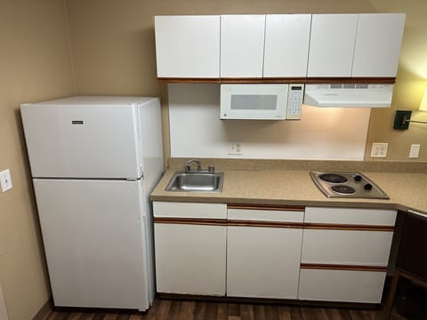 Fridge, microwave, stovetop, dining tables