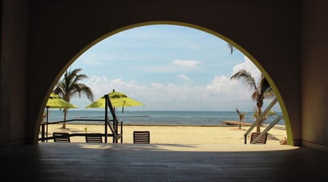 On the beach, white sand, sun loungers, beach towels