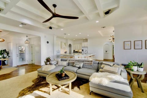 the main living room (there are two living rooms) has a plush U-shaped leather sofa and a swing chair