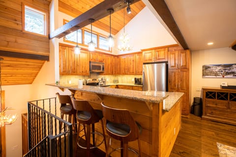 The bar area seats 3 comfortably in addition to the dining table that seats 8.