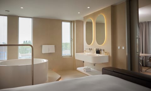 Suite (WOW Suite) | Bathroom | Separate tub and shower, rainfall showerhead, hair dryer, towels