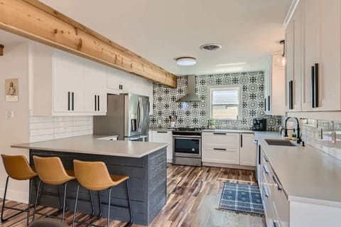 Spacious kitchen with a large island and seating, ideal for enjoying morning coffee or group meal prep.