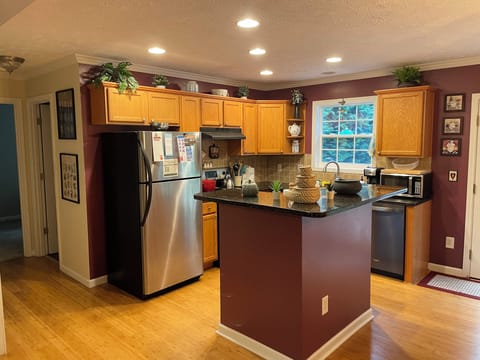 Fully stocked kitchen - pots, pans, plates, measuring cups, cutting board, etc.