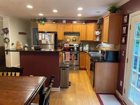 Fully stocked kitchen - pots, pans, plates, measuring cups, cutting board, etc.