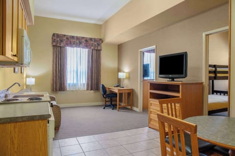 Suite, 1 Queen Bed, Non Smoking | Desk, blackout drapes, iron/ironing board, free cribs/infant beds