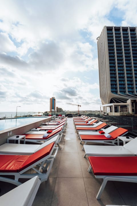 Seasonal outdoor pool, open 10:00 AM to 7:00 PM, pool umbrellas