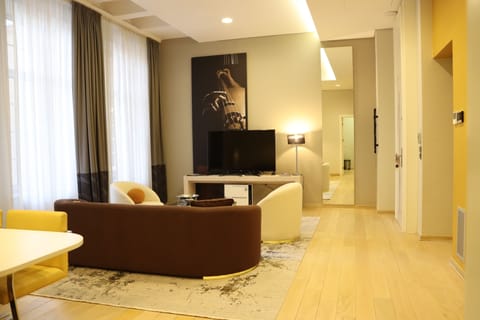 Grand Suite, 1 Bedroom | Living area | 32-inch flat-screen TV with cable channels, TV