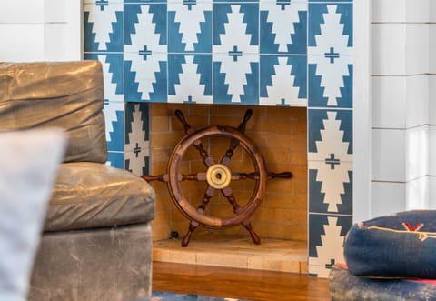 Charming fireplace with a nautical touch—cozy evenings start here.