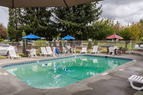 Seasonal outdoor pool, open 9:00 AM to 9:00 PM, pool umbrellas