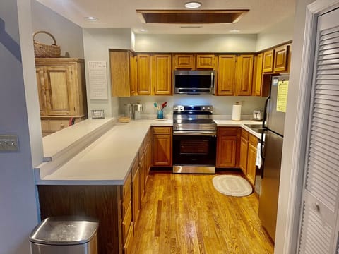 Fully stocked kitchen featuring new stainless appliances and everything you would need for cooking during your lake and mountain getaway.