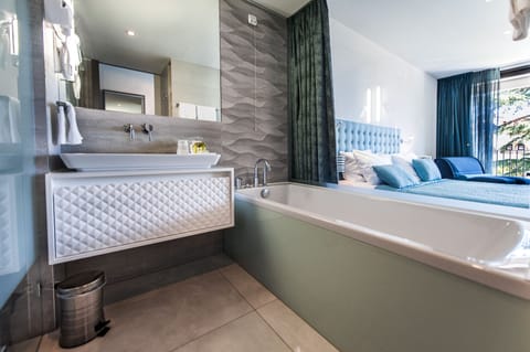Separate tub and shower, rainfall showerhead, designer toiletries