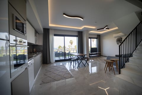Deluxe Duplex | Living area | Flat-screen TV, heated floors