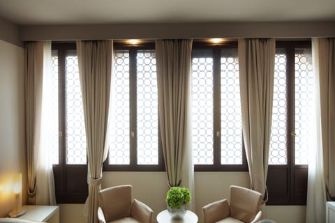 Junior Suite | Living area | 54-inch flat-screen TV with satellite channels, TV