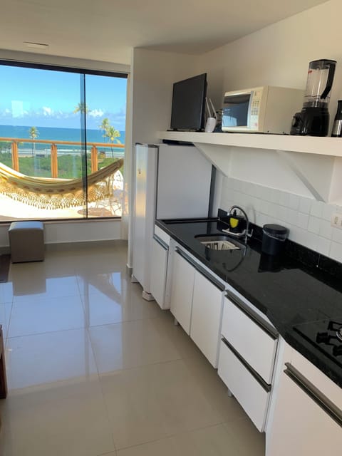 Deluxe Penthouse, 1 Bedroom, Beach View (202) | Private kitchen | Full-size fridge, microwave, stovetop, coffee/tea maker