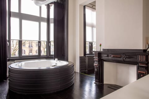 Suite, 1 King Bed | Bathroom | Combined shower/tub, jetted tub, designer toiletries, hair dryer