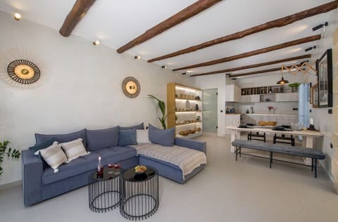 Αn open space, harmoniously combining the living room and the kitchen, offering a beautiful space and a large table for your meals.