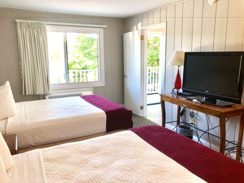 Deluxe King/Queen Room (Outside Entry with Patio) | Blackout drapes, iron/ironing board, free WiFi, bed sheets