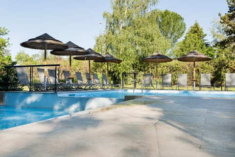 Seasonal outdoor pool, open 9:00 AM to 10:00 PM, pool umbrellas