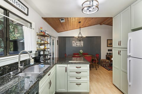 Open to the dining area - the kitchen has oodles of workspace, cabinets, storage.