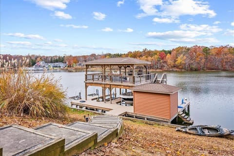 Impressive boat dock that features an amazing partially covered dock with a grill, smart TV, and lovely views of Lake Anna