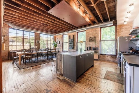 View of the dining area from the kitchen. Same open space with hardwood floor. 